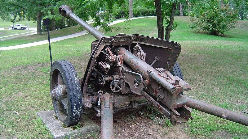 Photo of an old, large military gun on display outdoors